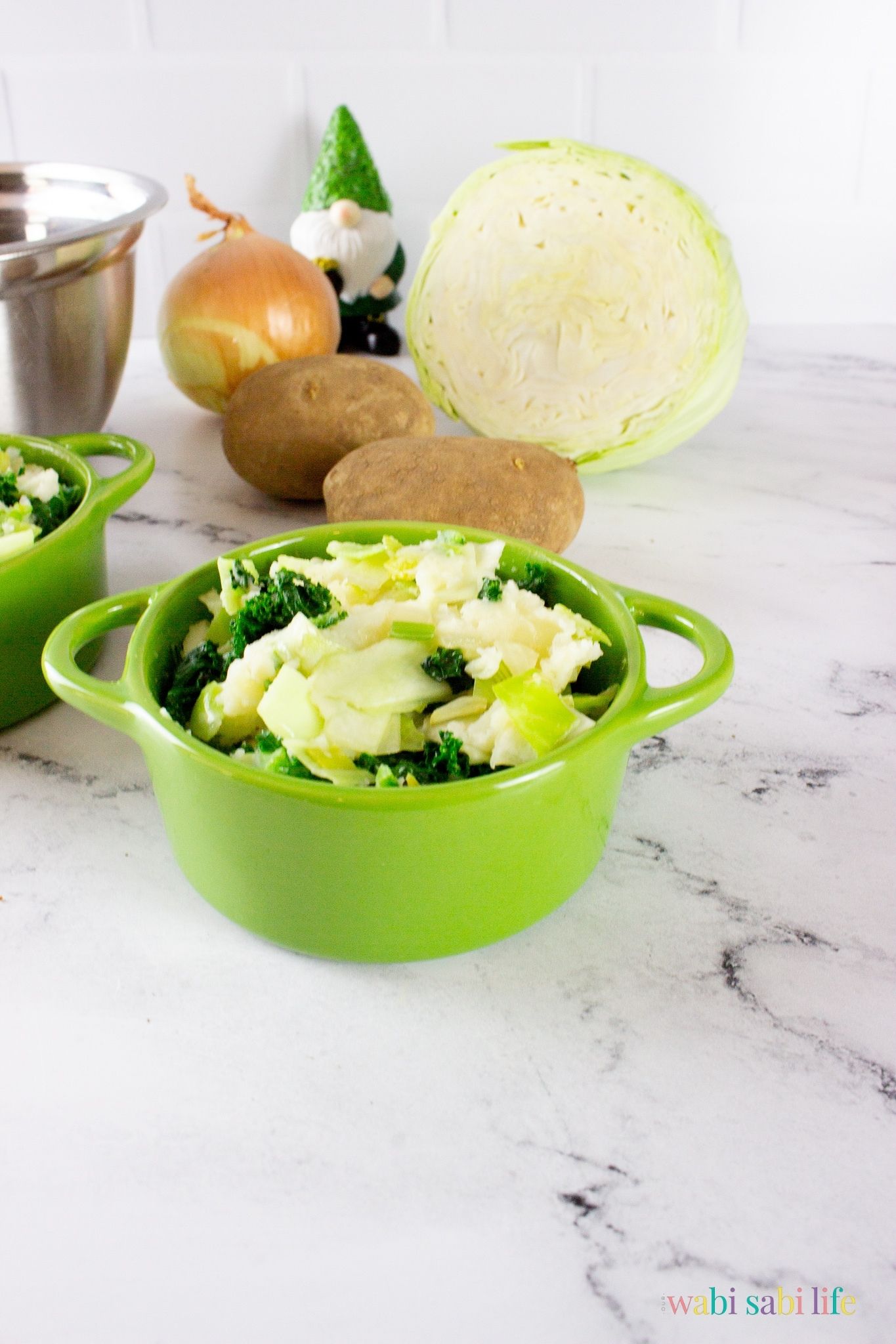A green pot of Irish Colcannon potatoes with kale, leeks, and cabbage