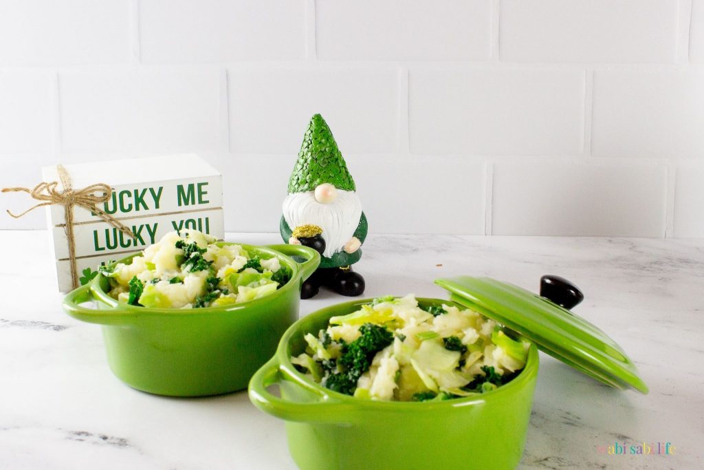 Two small green ceramic ramekins with lids full of Colcannon