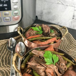 Pot Roast that has cooked in an Instant Pot with vegetables and topped with parsley