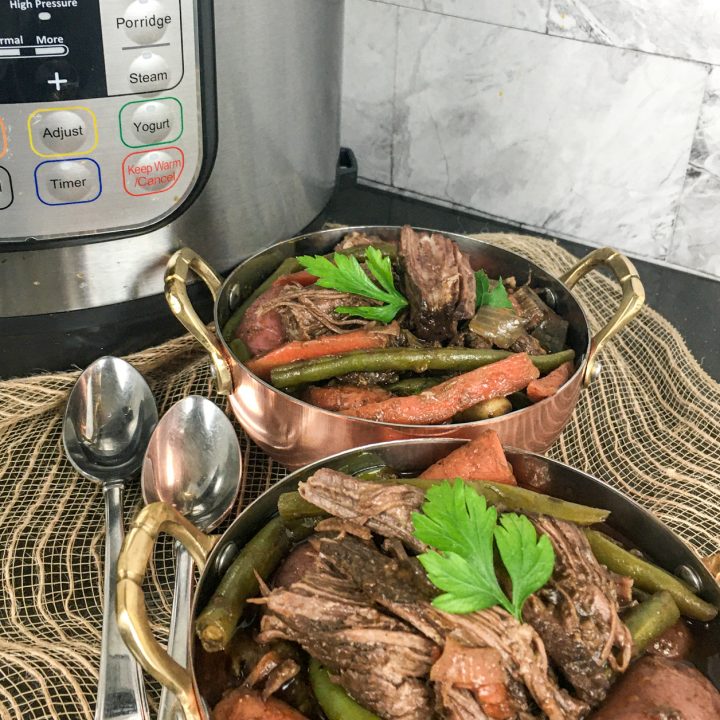 Pot Roast that has cooked in an Instant Pot with vegetables and topped with parsley