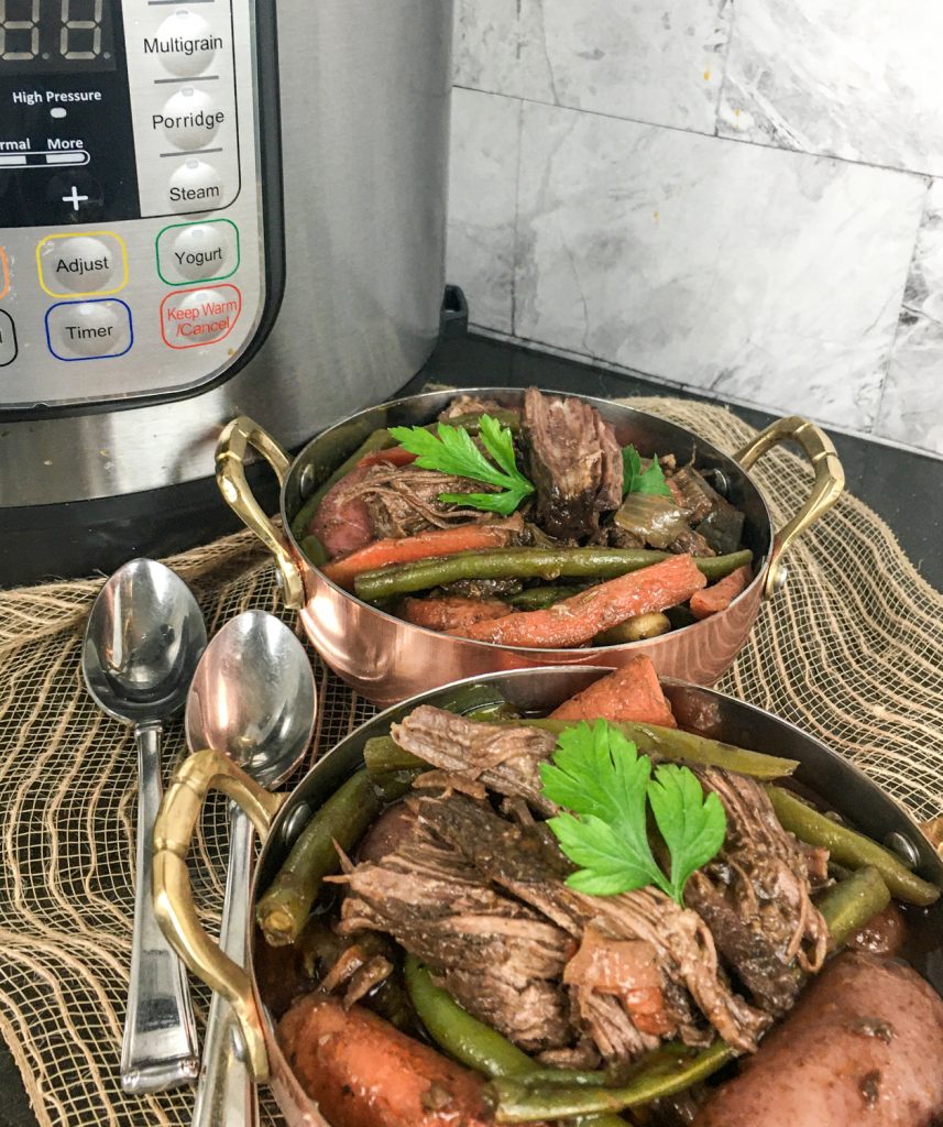 Pot Roast that has cooked in an Instant Pot with vegetables and topped with parsley