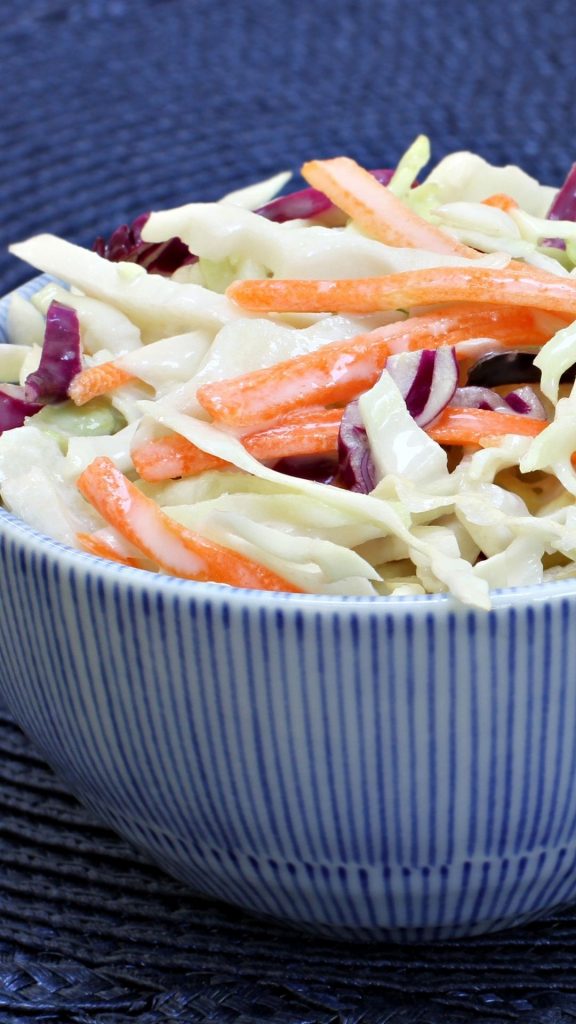 close up of coleslaw in a blue bowl