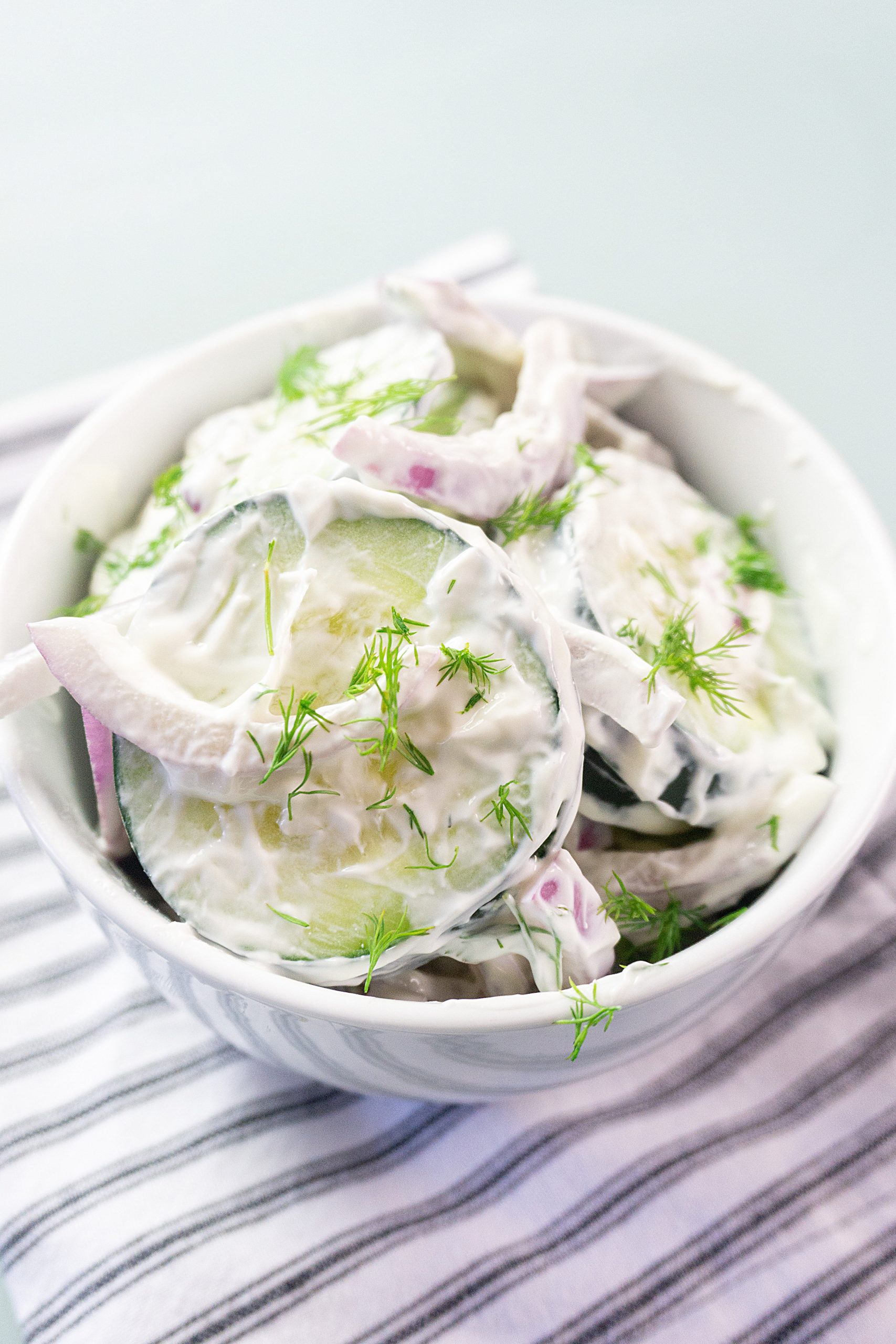 cucumber salad in a white bowl