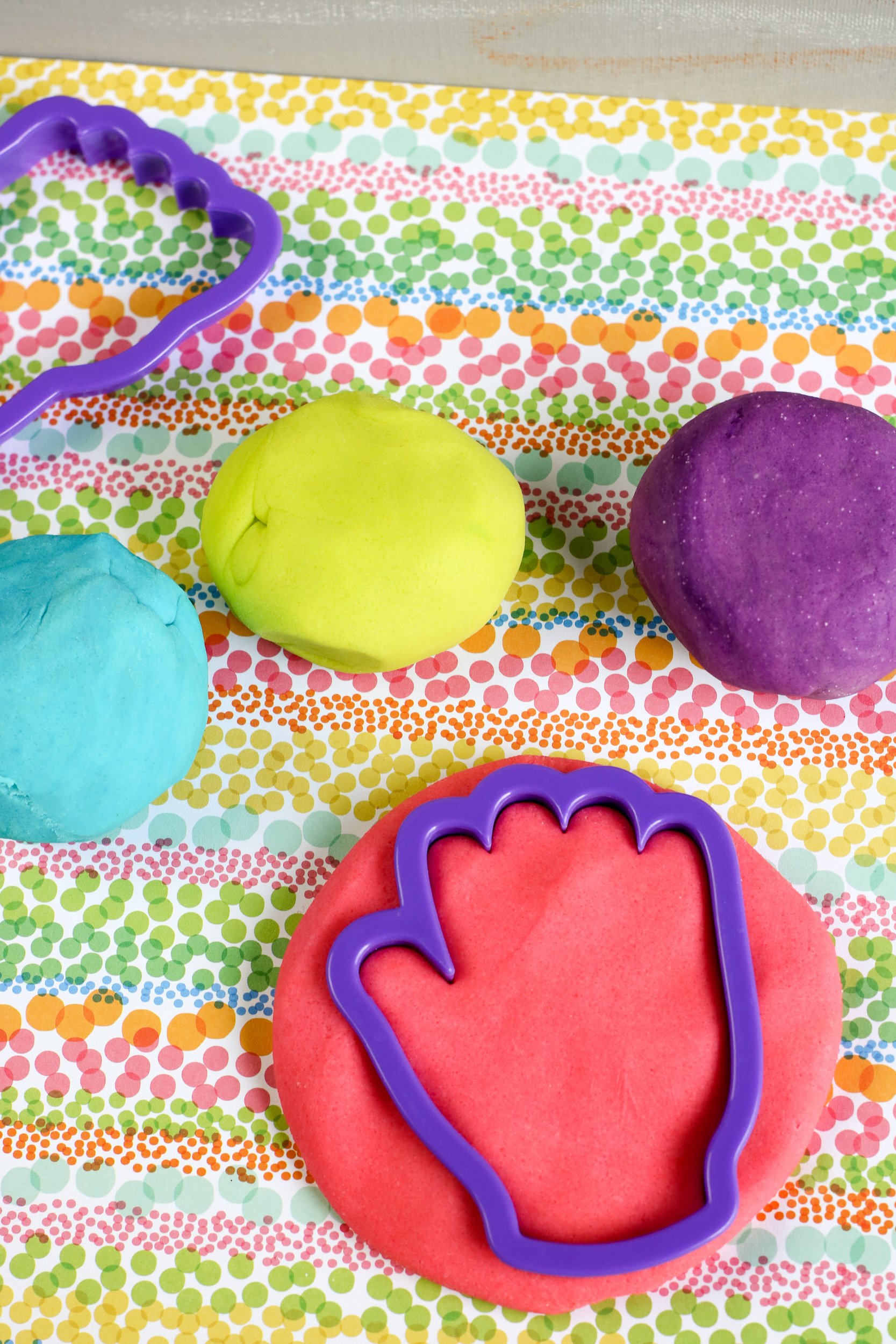 Some playdough with a cutter making a shape.