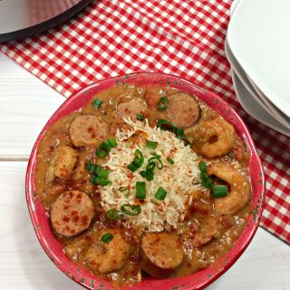 Instant Pot Gumbo served with cooked rice and garnished with chives.