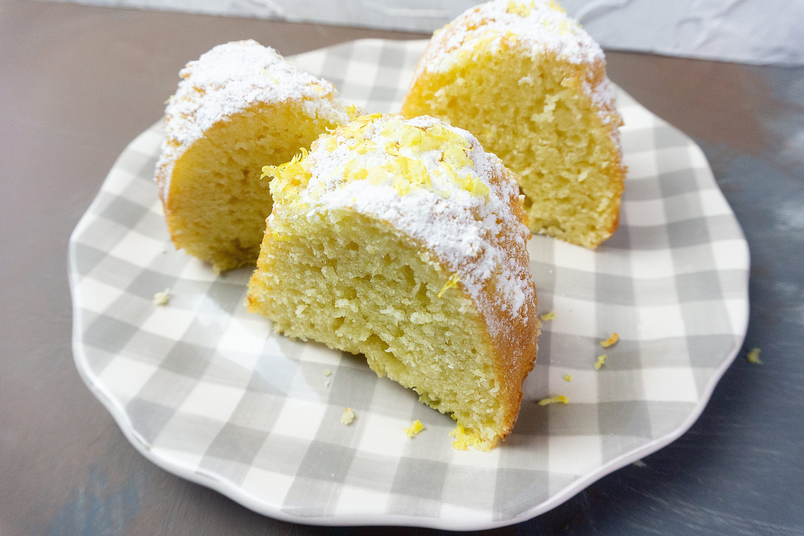 Meyer Lemon Bundt Cake on a grey and white checkered plate.