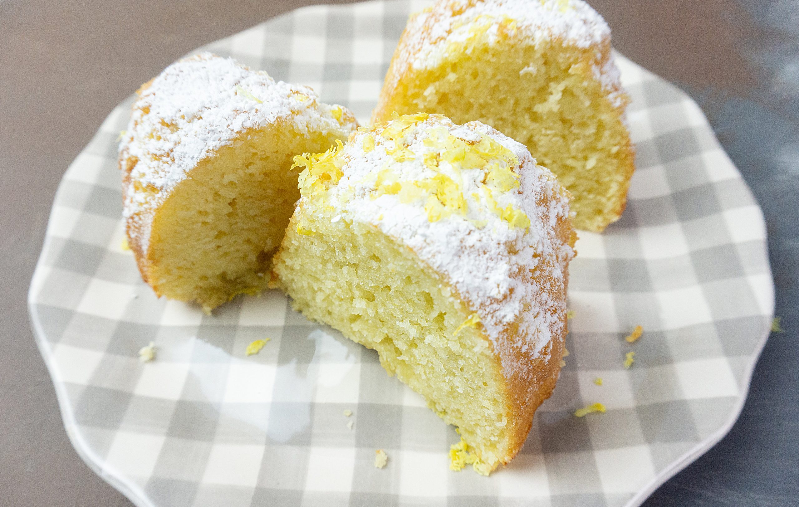 Meyer Lemon Bundt Cake topped with powdered sugar and lemon zest.