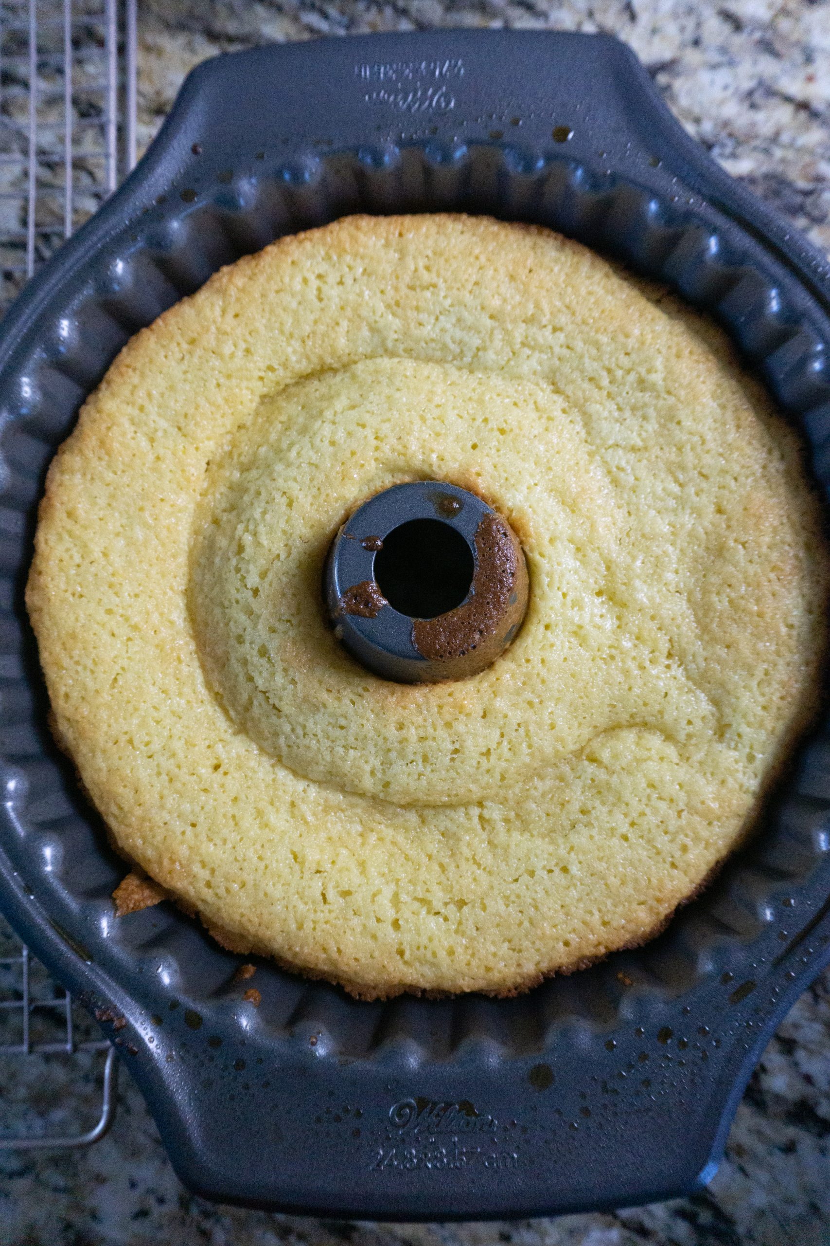 The baked cake cooling in the pan.