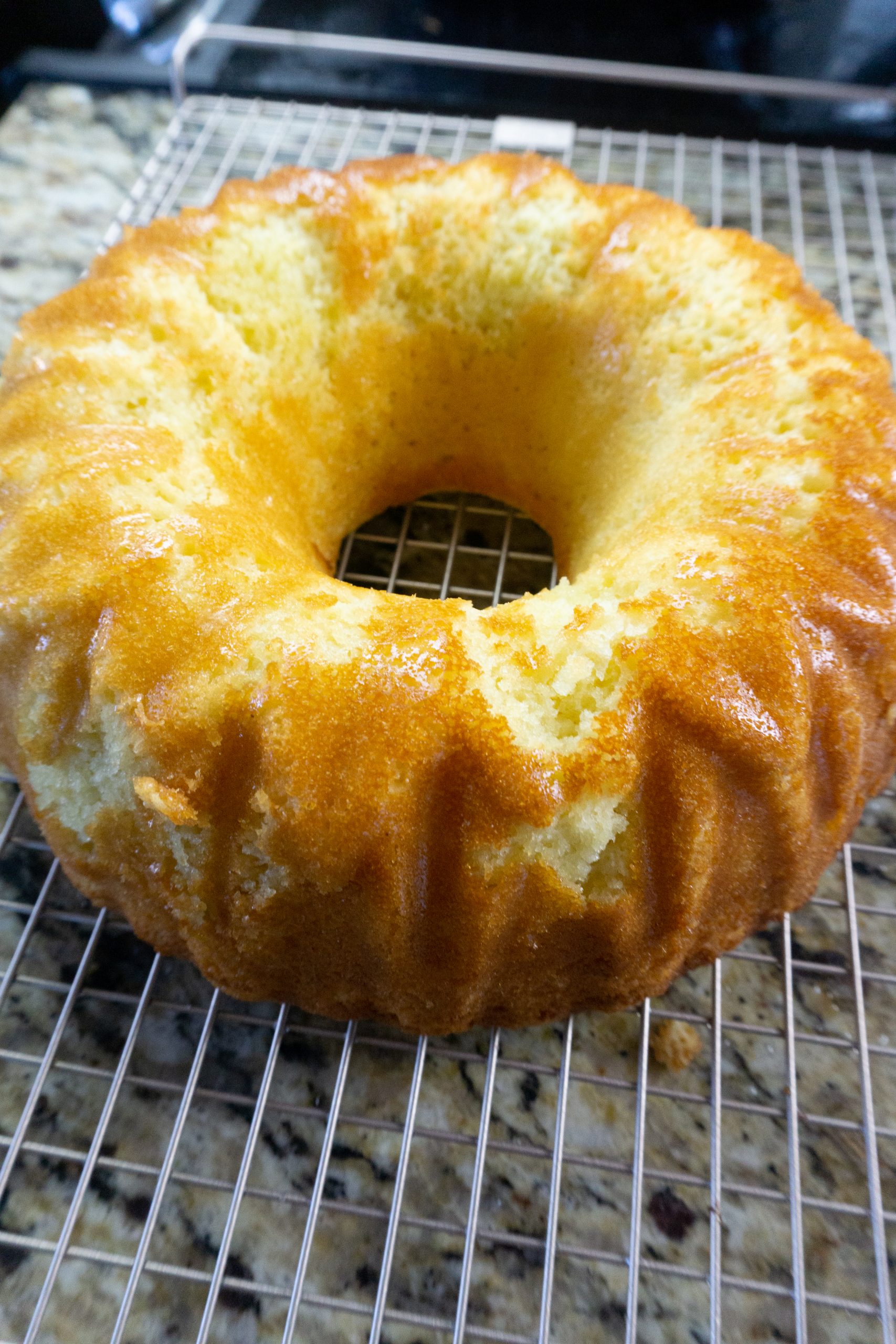 Meyer Lemon Bundt Cake on a wire rack cooling.