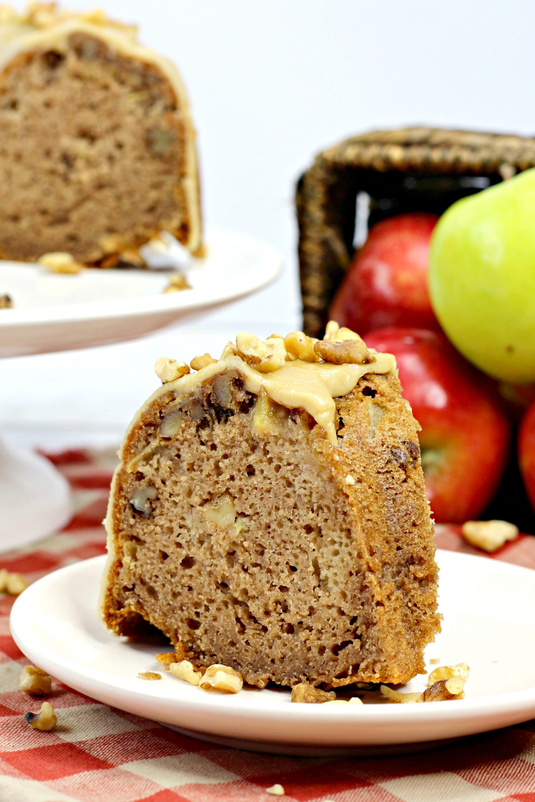 A slice of the apple Bundt cake on a serving platter.