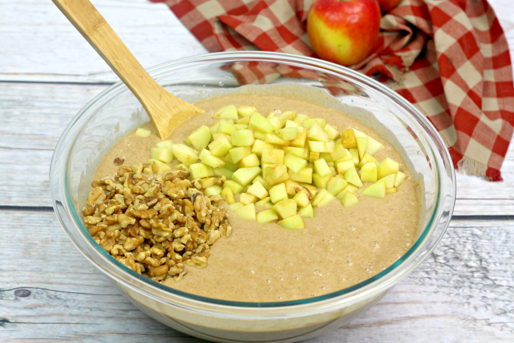 Adding the apples and walnuts into the batter.