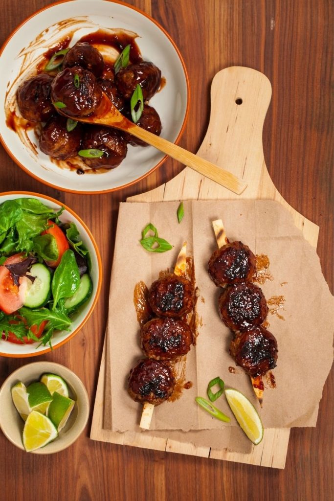 BBQ meatballs on a brown cutting board