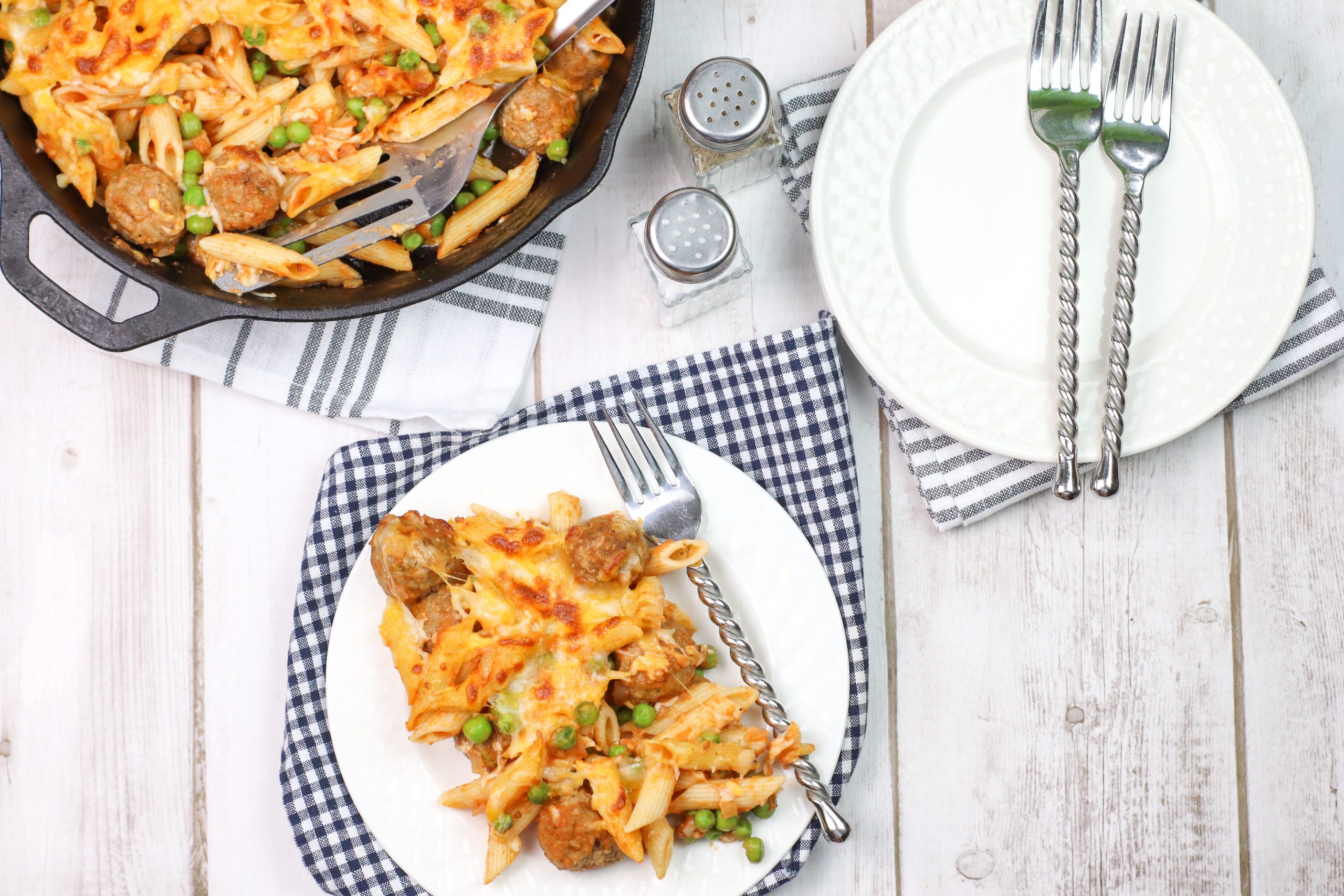 skillet pasta with meatballs on a white plate