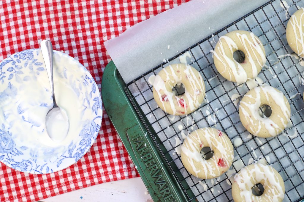 strawberry donuts on cooling rack