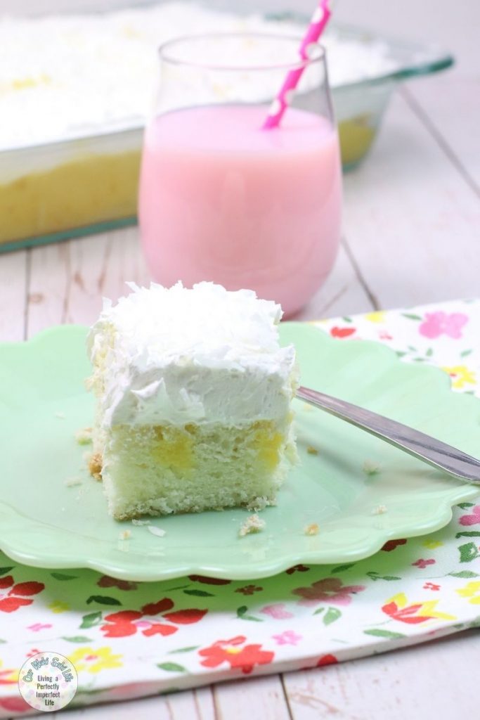 coconut poke cake on a flower patterned mat.