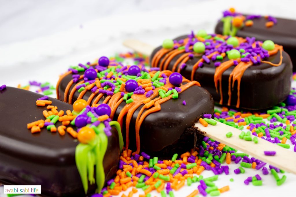 Hocus Pocus Cakesicles topped with sprinkles.