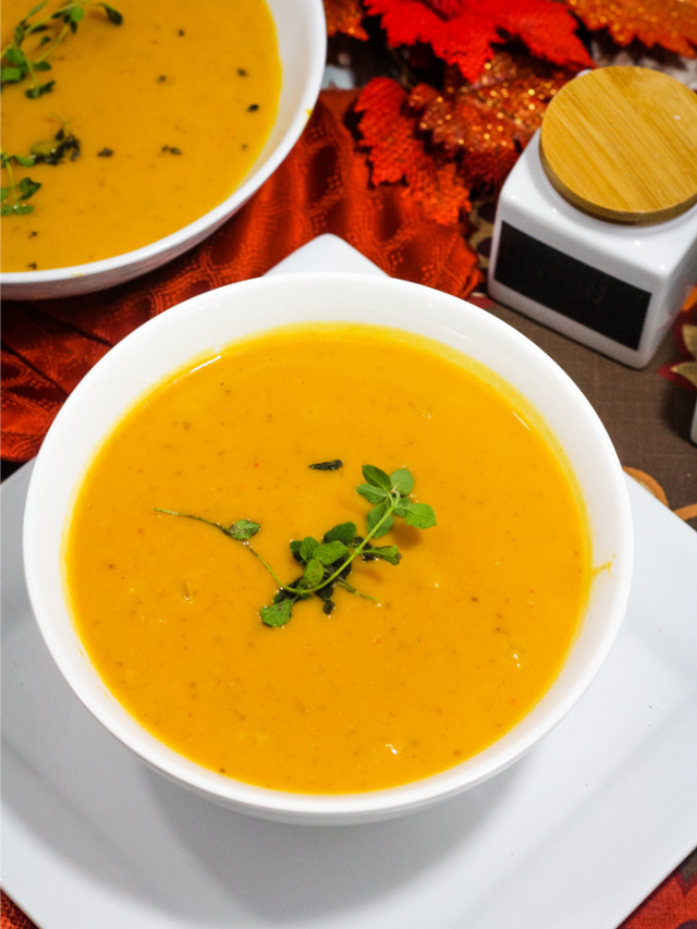 Autumn Squash Soup in a bowl with garnish on top.