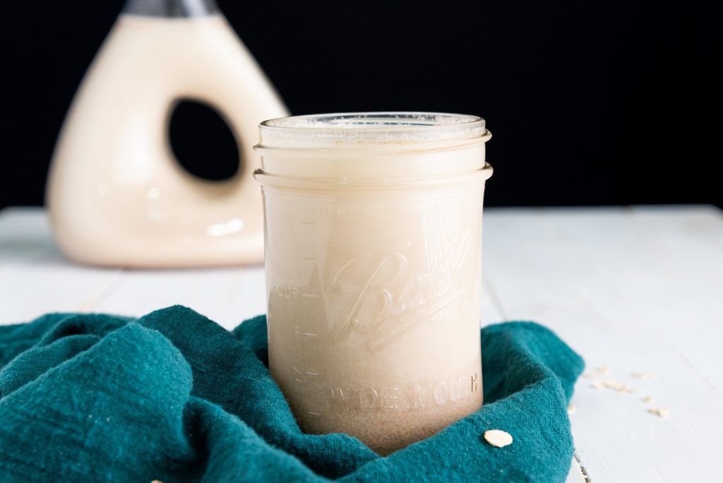 oat milk in a jar with a green napkin