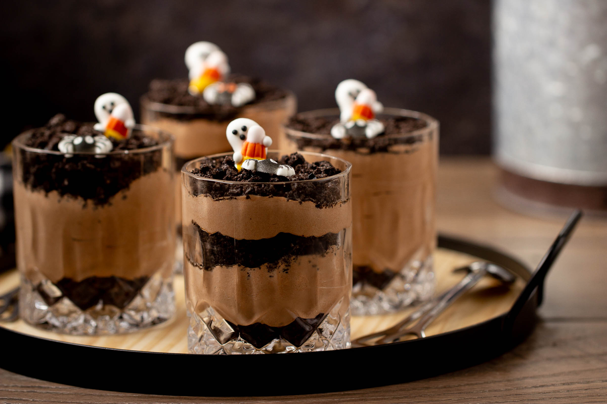 Halloween dirt pudding cups with ghost decorations on top