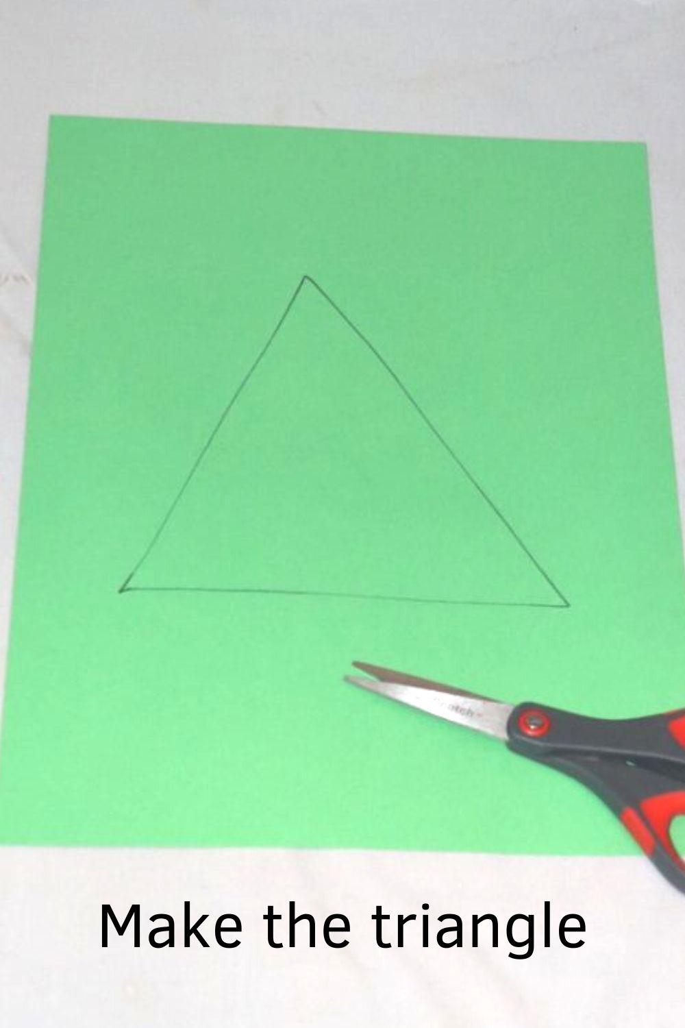 green paper with a triangle on it