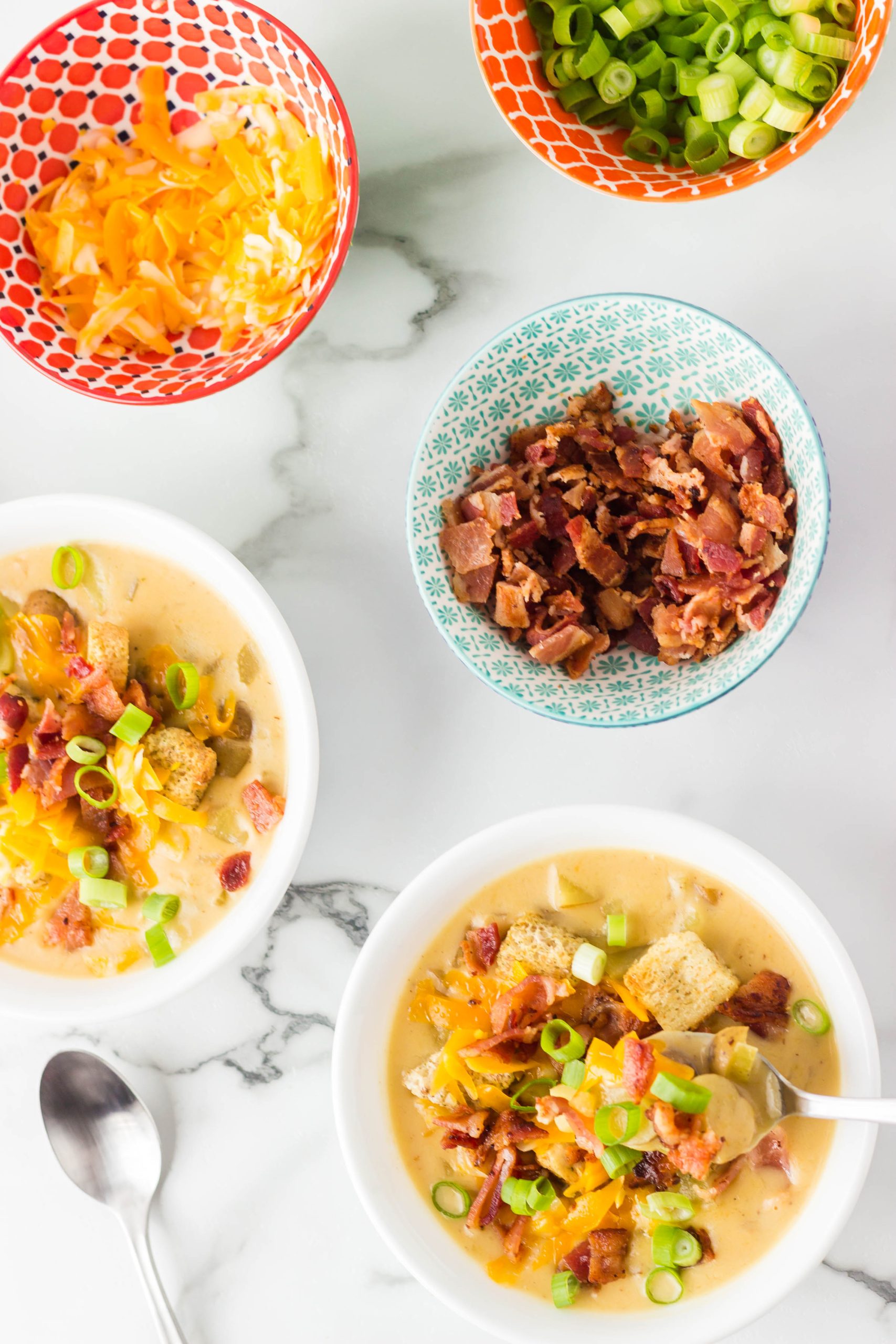 Irish Ale Potato Cheddar Soup in bowls with toppings