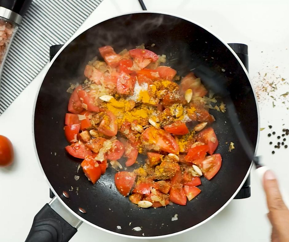 tomatoes and spices in a frying pan