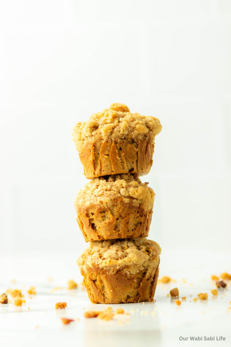 Three Coffee Cake Muffins stacked on top of each other.