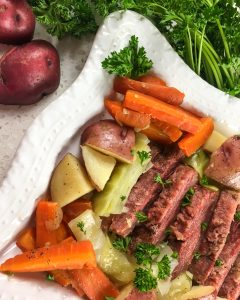 Instant Pot Corned Beef and Cabbage with Guinness  on a white plate