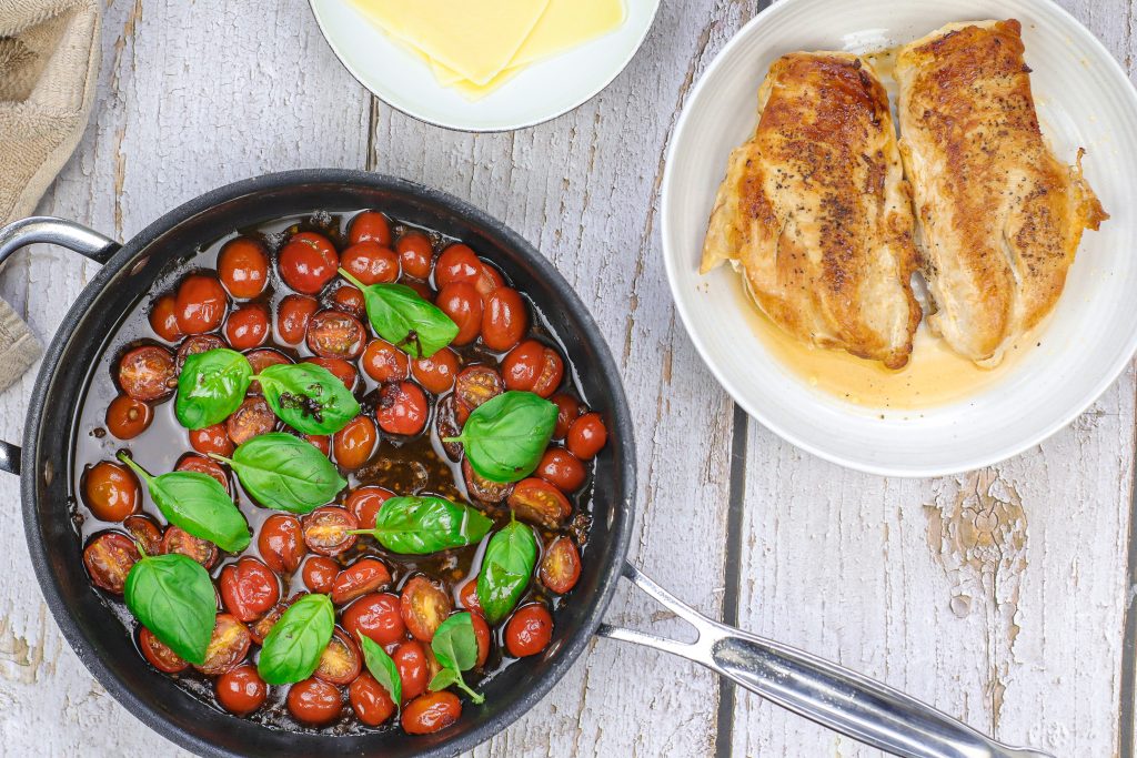 tomatoes and basil cooking in the pan