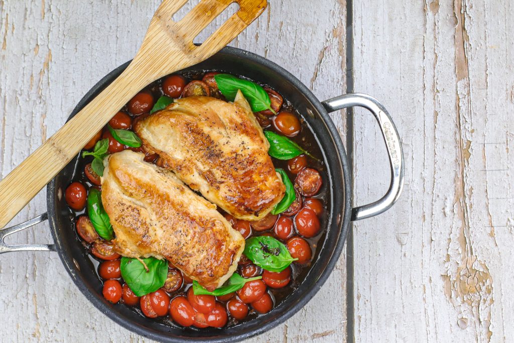 adding the chicken on the tomatoes