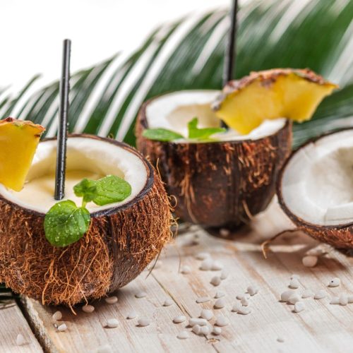 2 drinks inside of coconuts