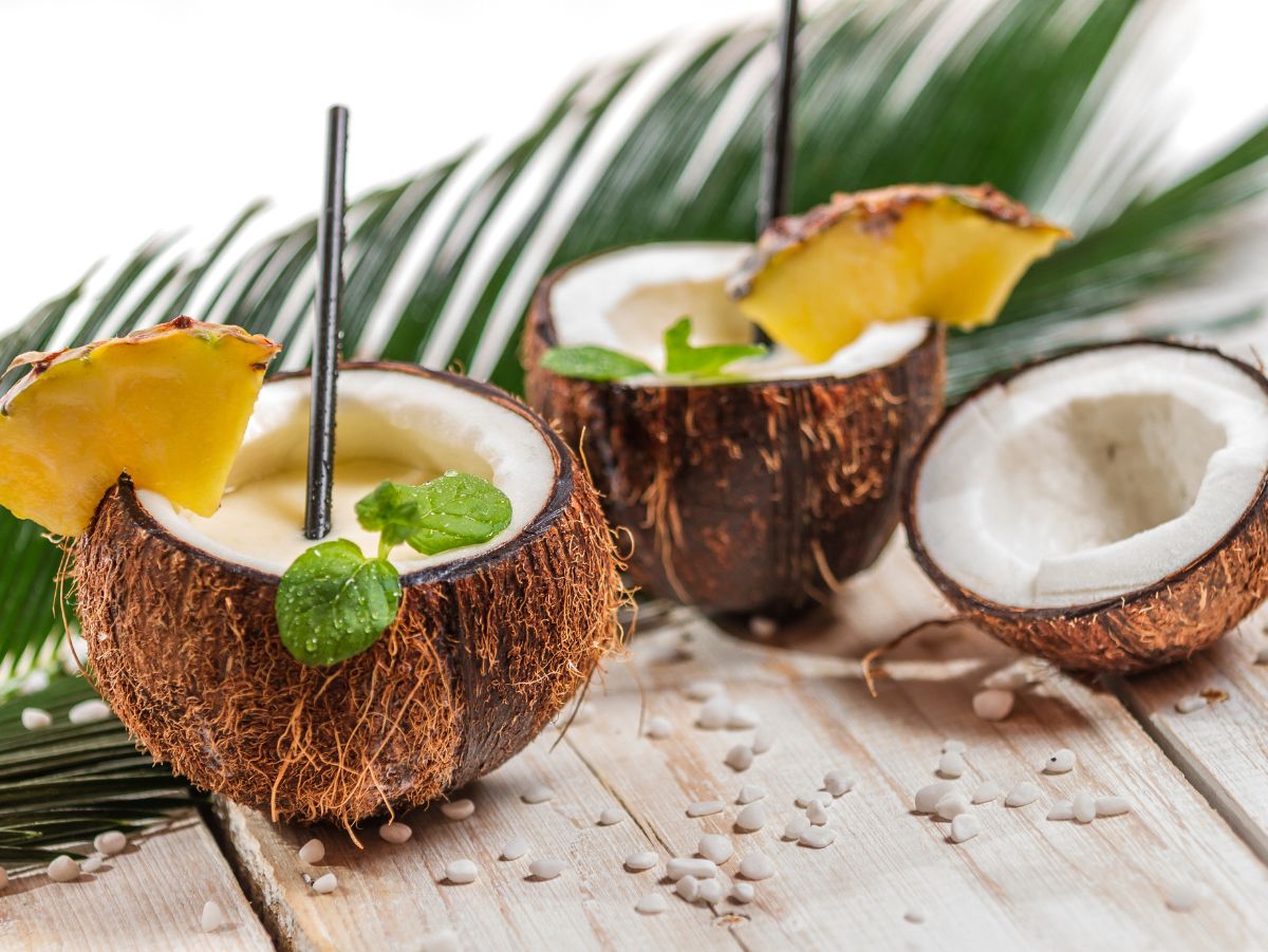 2 drinks inside of coconuts