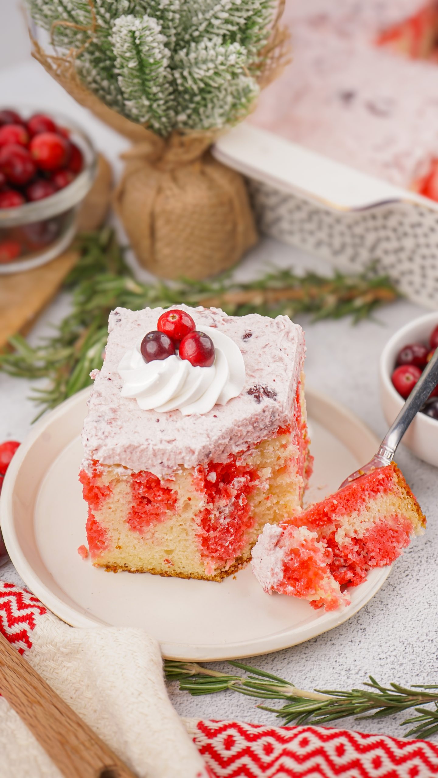 cranberry poke cake with a bite on fork