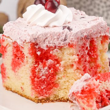cranberry poke cake on white plate