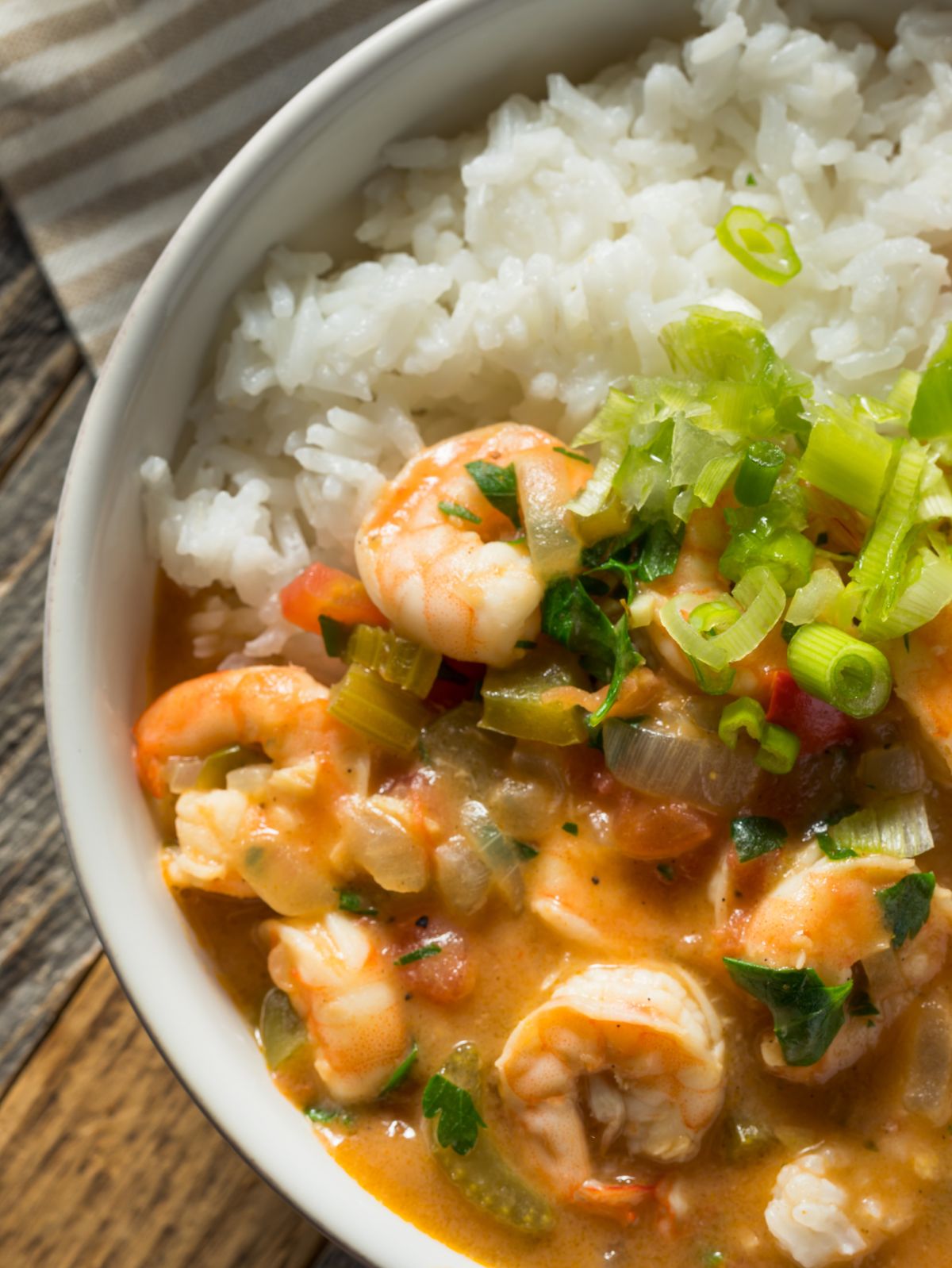 Cajun Shrimp Etouffe in a white bowl with rice