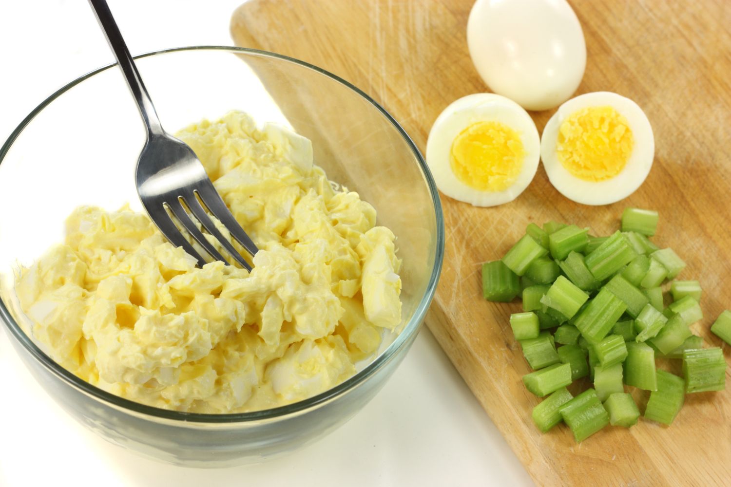 egg salad with eggs and celery on a cutting board