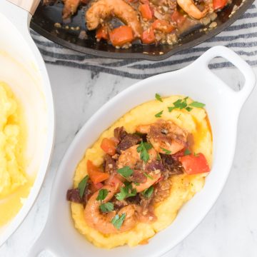 cajun shrimp and grits in a white bowl