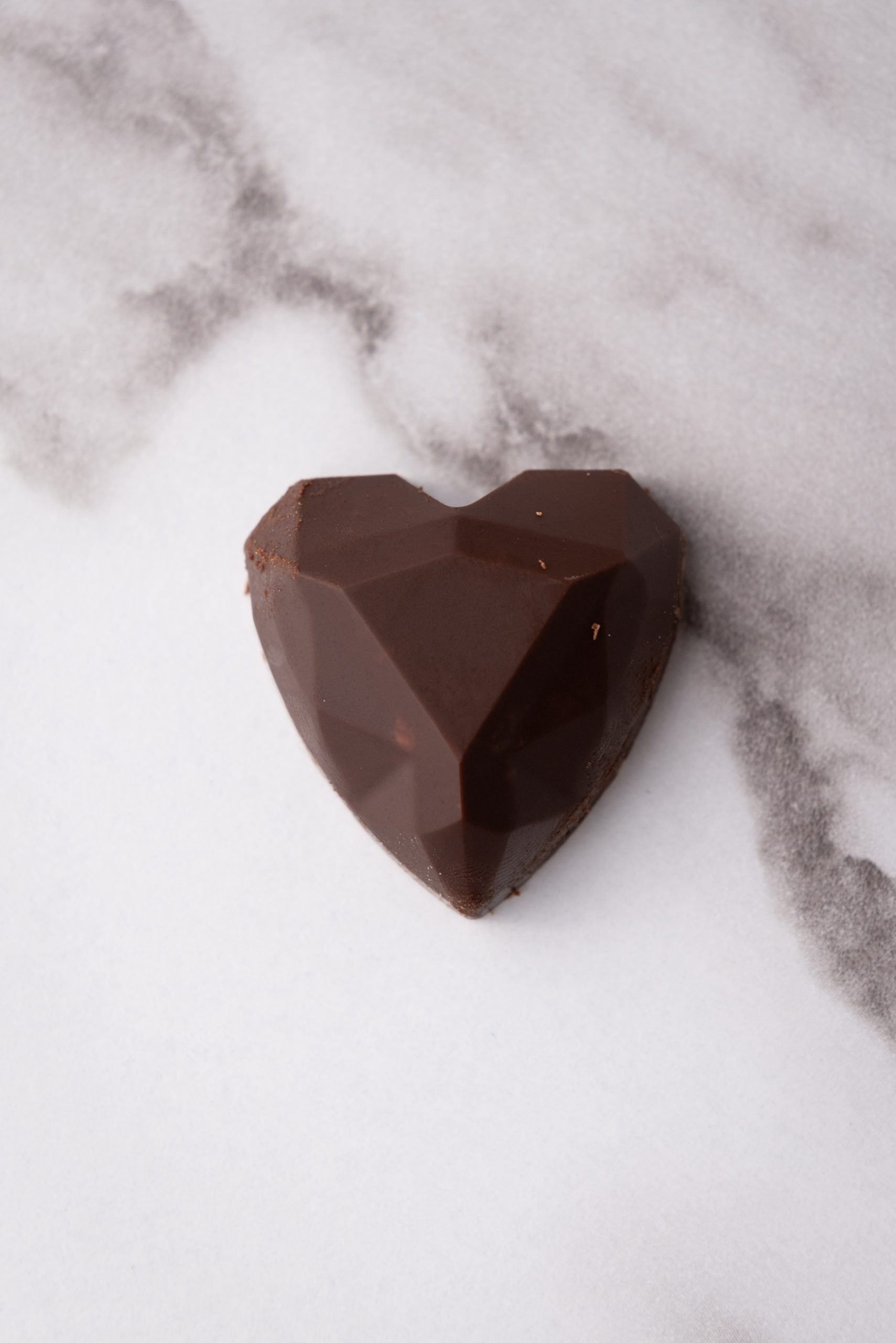 single nutella truffle on a marble surface