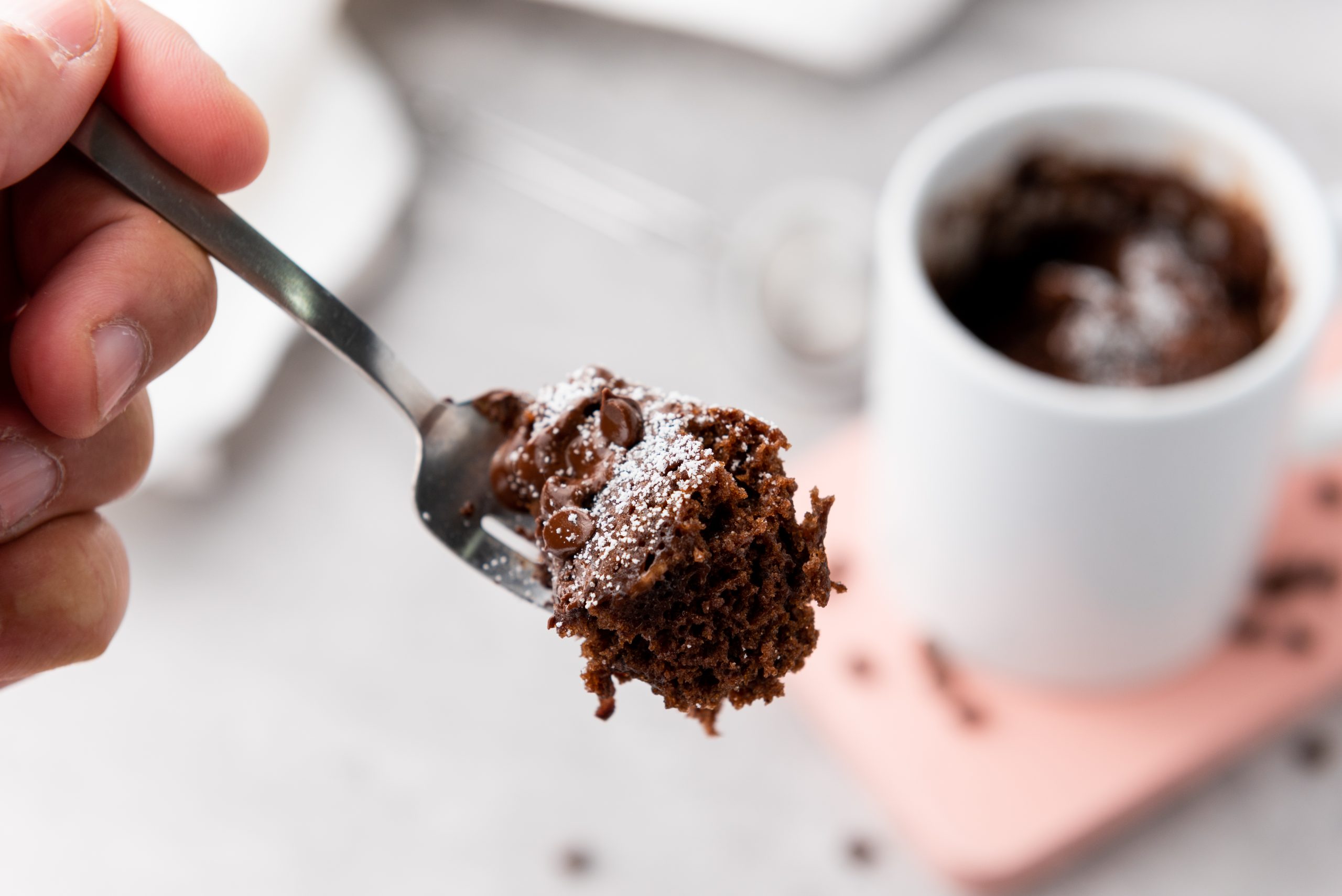 brownie in a mug with a bite on a fork