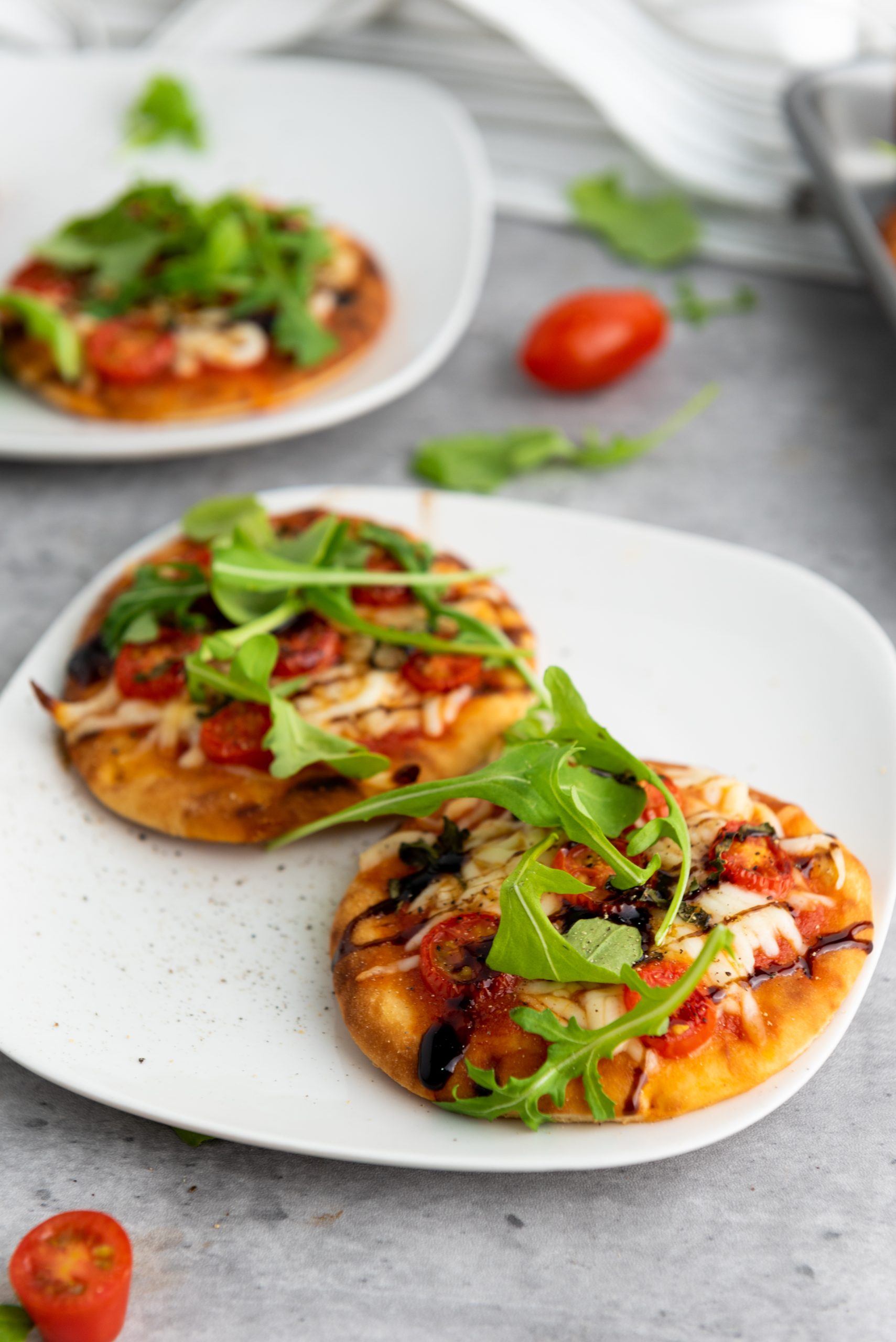 mini caprese pizza on a white plate