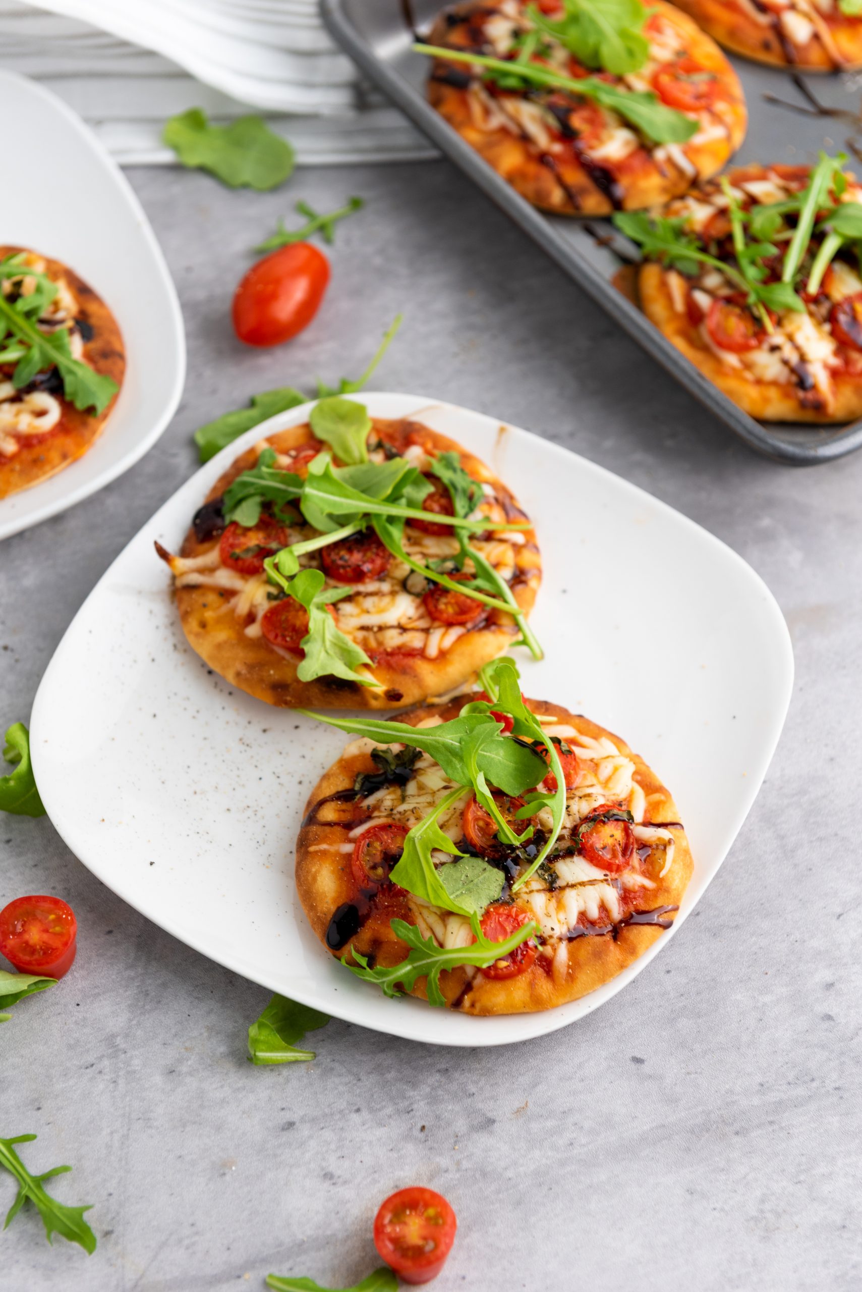 caprese pizza on a white plate