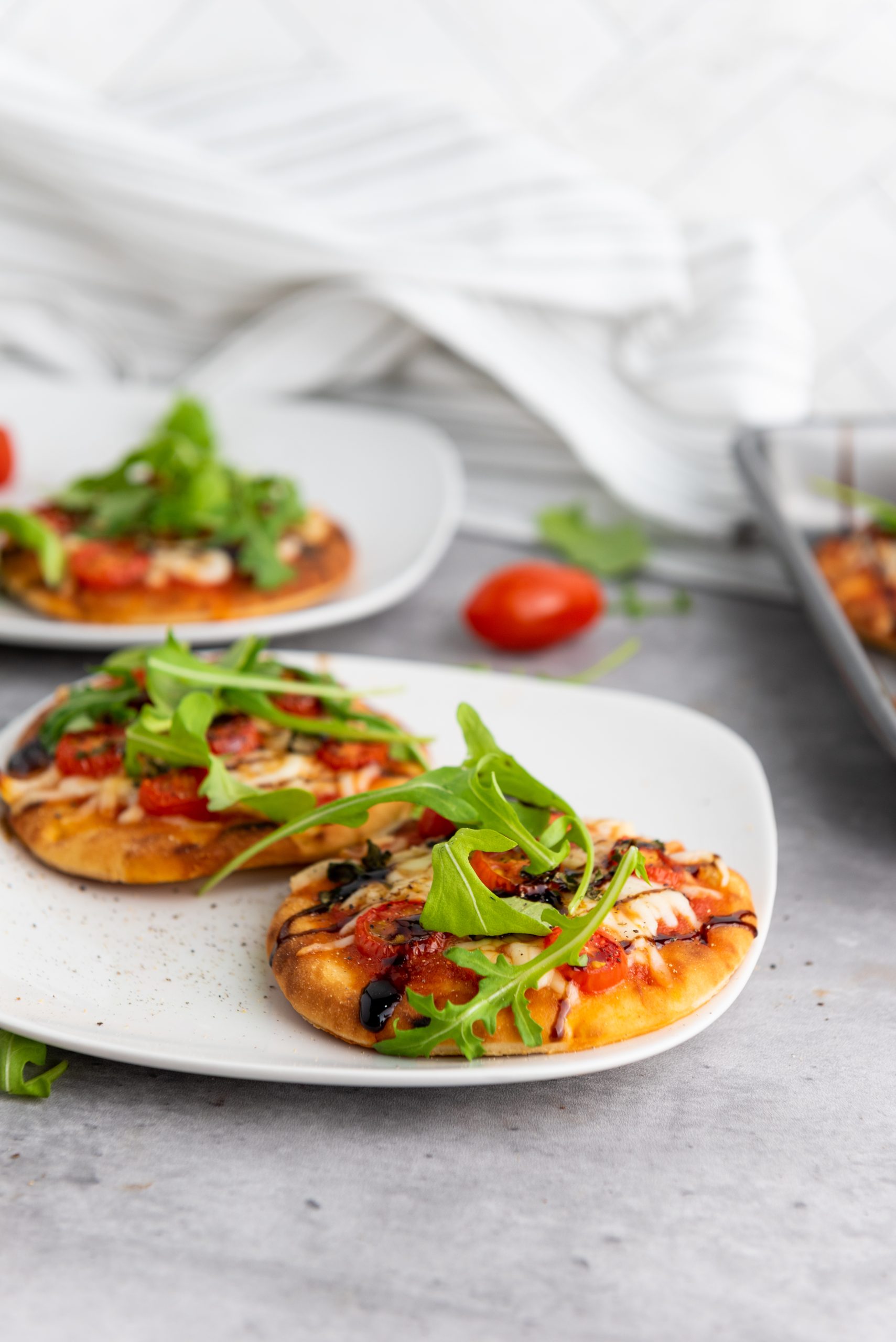 caprese pizza on a white plate