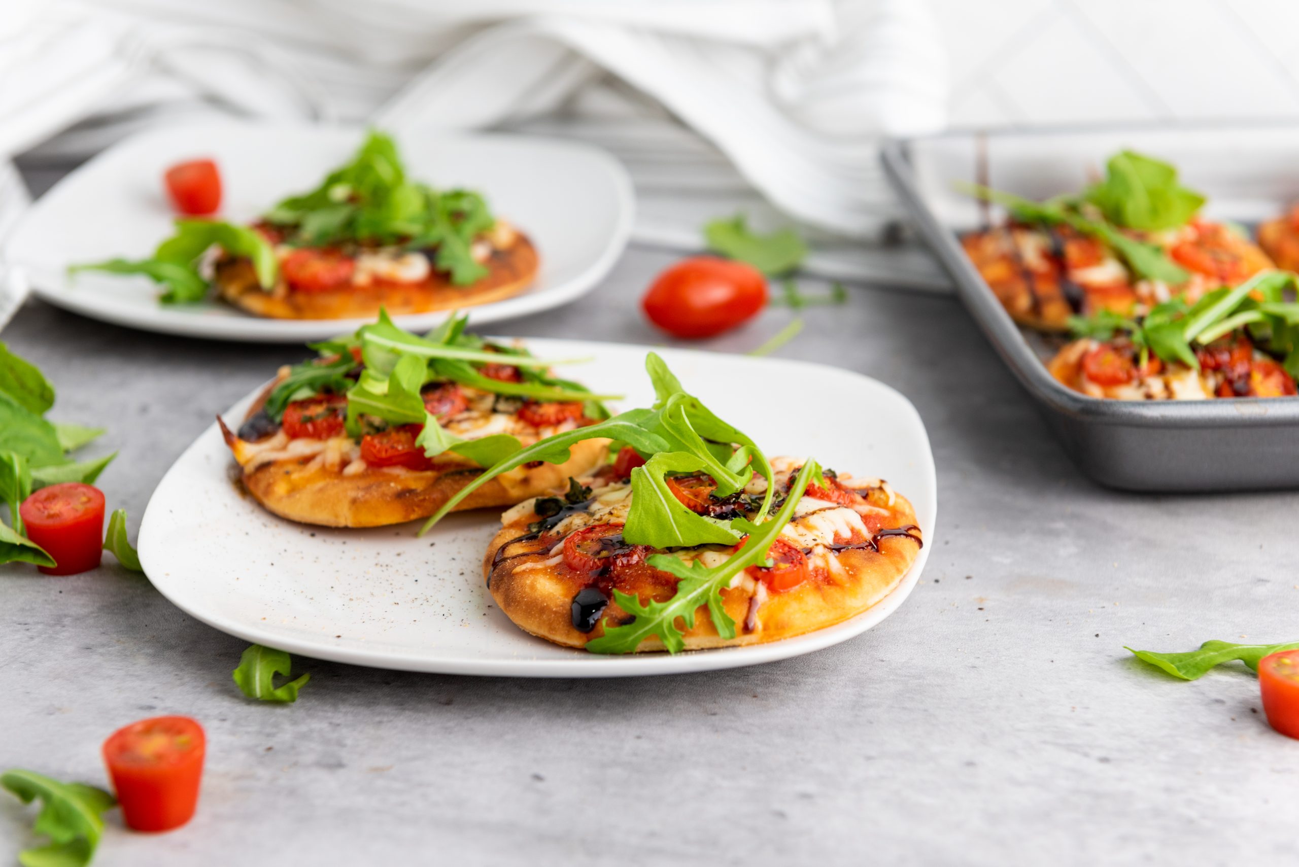 caprese pizza on white plates