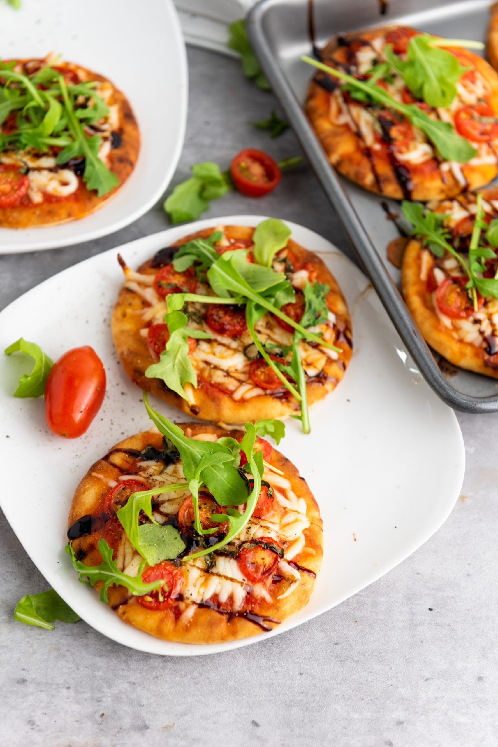 overhead image of 2 mini caprese pizzas