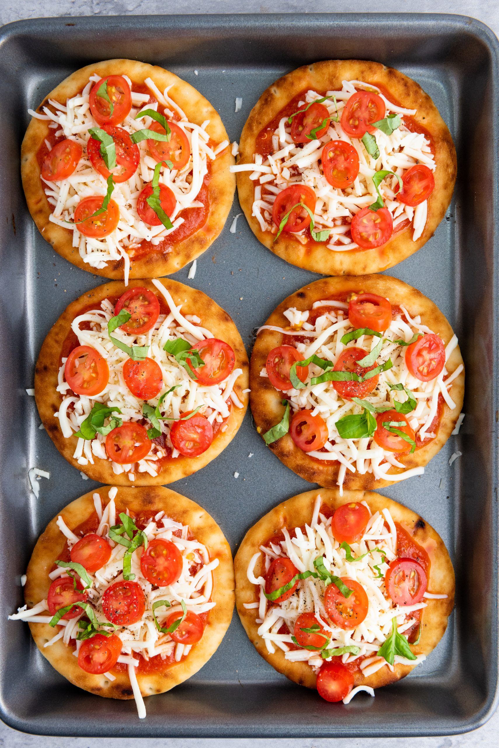 uncooked pizza on a baking sheet