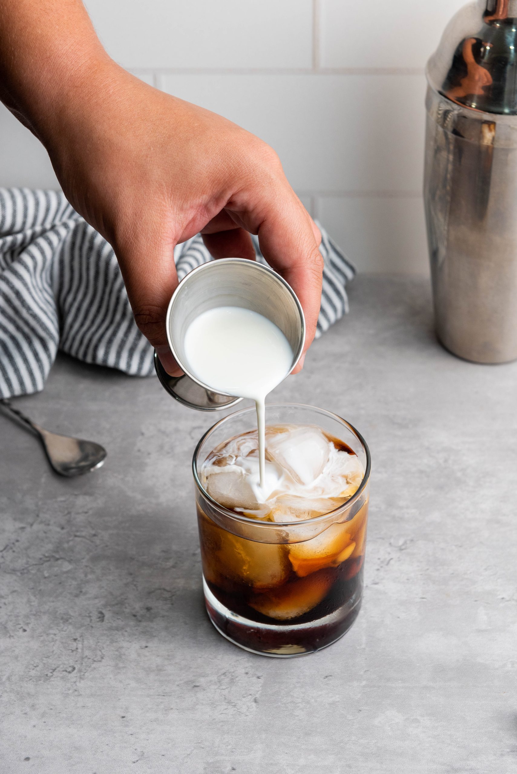 adding heavy cream to the drink