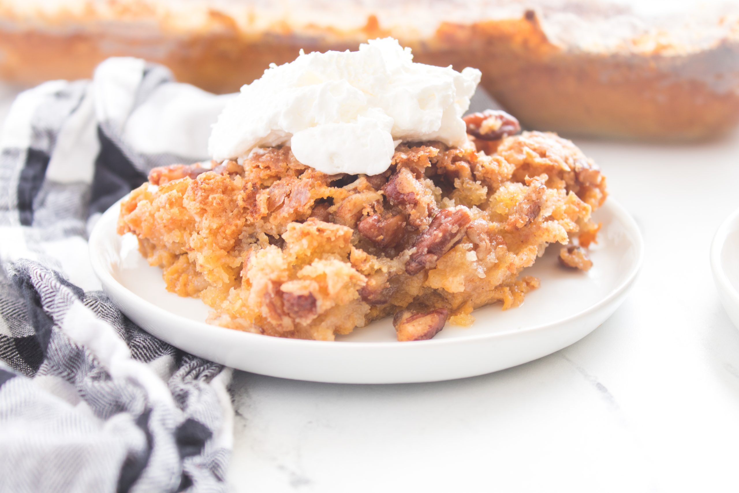 easy pumpkin dump cake on a white plate