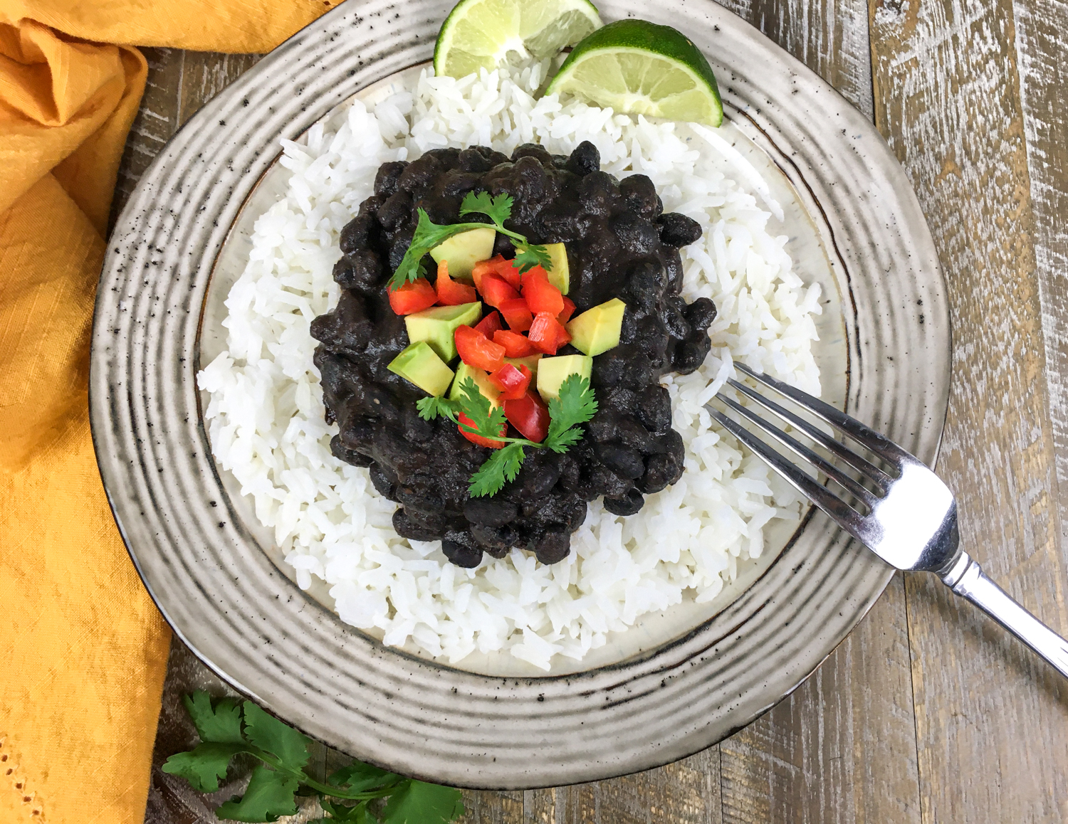 A plate full of the recipe with lime wedges and other garnishes.