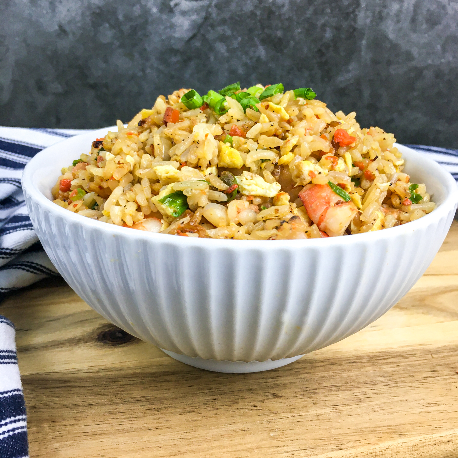 Easy Shrimp Fried Rice with a striped cloth next to it.