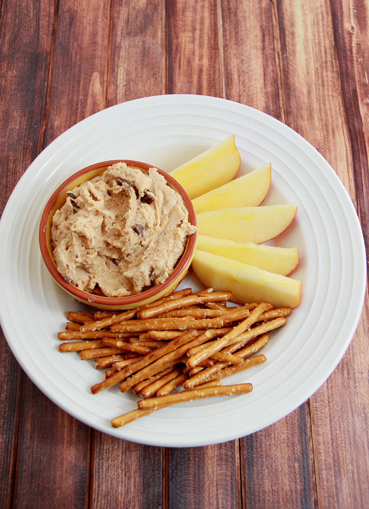 Cookie Dough Dip served with pretzels and apples.